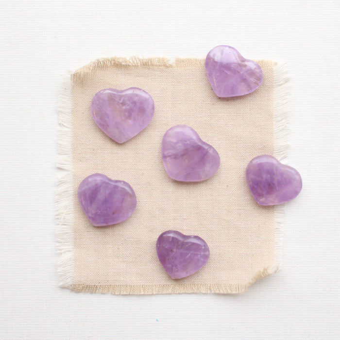 6 amethyst stone hearts on tan linen