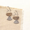 Stamped silver and bronze Asmi mixed duo earrings styled on tan linen