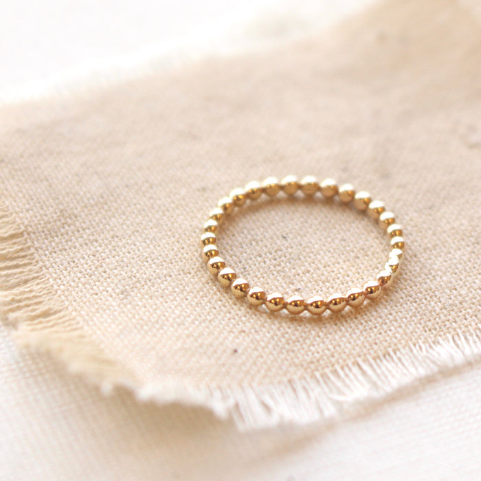 14k gold fill beaded ring styled on tan linen