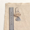 Stamped silver and bronze Asmi mixed duo earrings next to a ruler for size reference