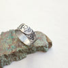 Silver stamped buffalo ring styled on a green rock