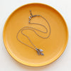 The stamped leaf trio necklace showing the adjustable lobster clasp closure