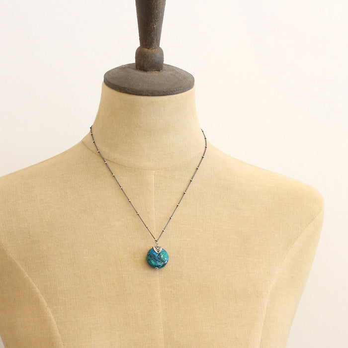 A mannequin wearing the capped chrysocolla necklace