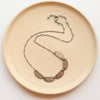 The stamped bronze and silver asmi five collar necklace showing adjustable lobster closure