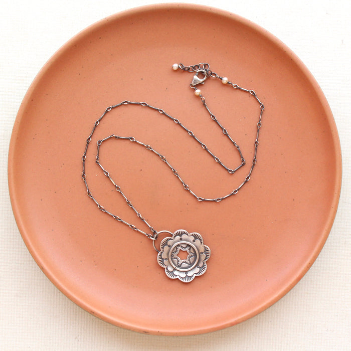 The columbine stamped silver necklace showing the adjustable lobster clasp closure