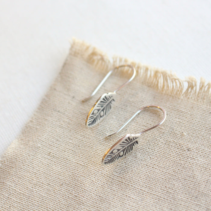 The stamped silver feather lobe huggers showing the lobe hugger earwires