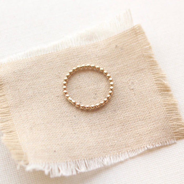 14k gold fill beaded stacking ring styled on tan linen