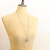 A mannequin wearing the pakal teardrop cutout turquoise long necklace