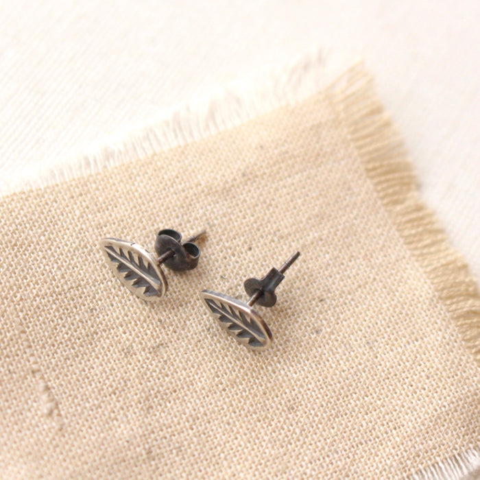 The stamped silver leaf post earrings showing the butterfly backs.