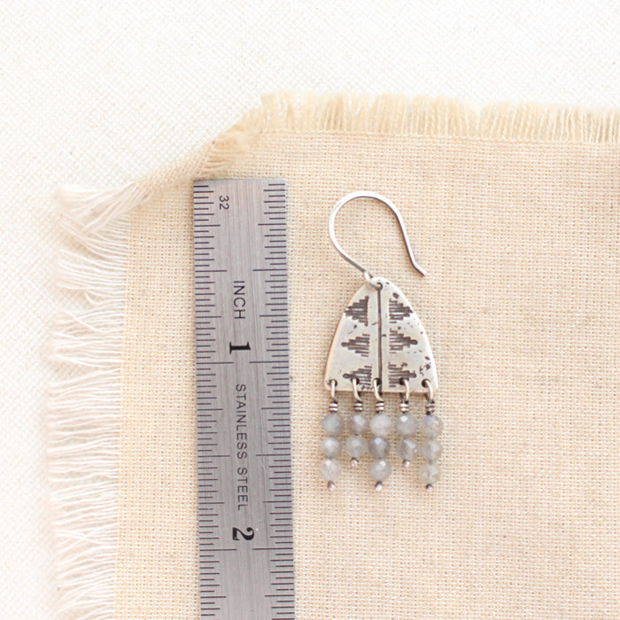 A pakal arch labradorite fringe earring next to a ruler for size reference