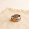 Oxidized bronze and silver mountain ring styled on tan linen