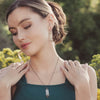 A model wearing the celestial bar hematite earrings and matching necklace