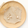 the perfect pearl gold set styled on a tan plate with linen and dried grass