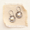 pearl sun scallop cupped earrings on tan linen