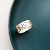 The stamped mountain range ring styled on a blue plate