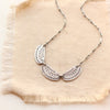 The asmi trio collar necklace styled on tan linen
