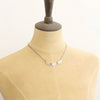 The asmi trio collar necklace styled on a mannequin to show the length
