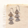 the asmi trio triangle long earrings styled on tan linen