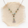 the asmi triangle turquoise lariat necklace styled on tan linen