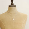 A mannequin wearing the bright silver perfect pearl necklace