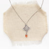 the layered talara sunstone drop necklace styled on tan linen