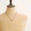 A mannequin wearing the layers of love heart necklace