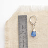 A kyanite drop earring next to a ruler for size reference