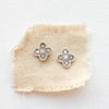 The mini talara post earrings styled on tan linen
