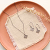 The mini talara set styled on a red plate with linen and dried grass