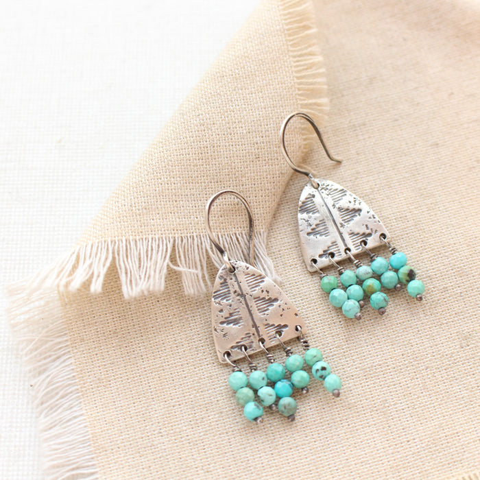 The pakal arch turquoise fringe earring styled on tan linen
