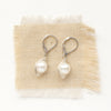 The perfect pearl silver wrapped earrings styled on tan linen