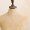 A mannequin wearing the pink sapphire and moonstone charm necklace