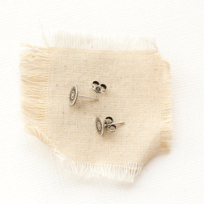 The talara sun post earrings styled to show the butterfly backs