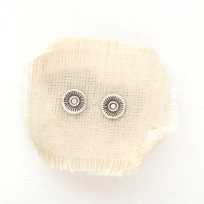 The talara sun post earrings styled on tan linen