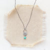 The turquoise jolie necklace styled on tan linen